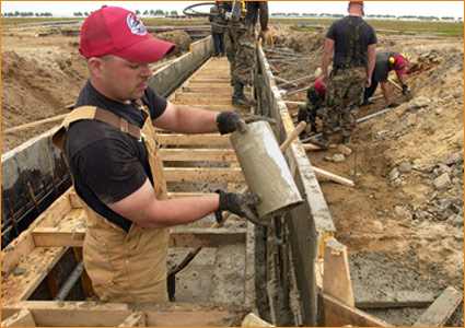 Pouring concrete into the wood forms at the Kunsan air base